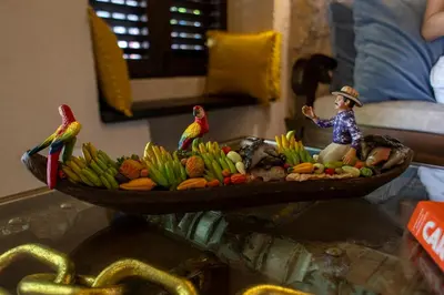 a plate of fruit with a woman and birds on it at Casa Santino Luxury Getsemaní-Cartagena in Cartagena de Indias