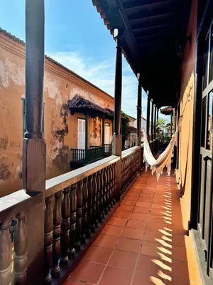 a balcony with a hammock in a building at Casa Estrella Colonial Mansion in Cartagena de Indias