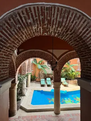 an archway over a swimming pool in a house at Casa Estrella Colonial Mansion in Cartagena de Indias