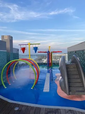 a pool with a water slide on top of a building at Apartamento con salida privada a la playa en Morros, Cartagena in Cartagena de Indias