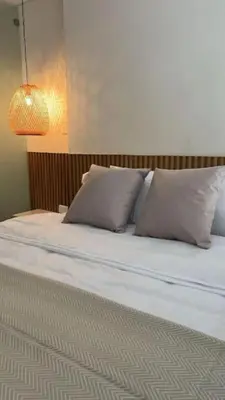 a bed with two pillows on top of it at Appartement neuf centre Cartagena la matuna in Cartagena de Indias