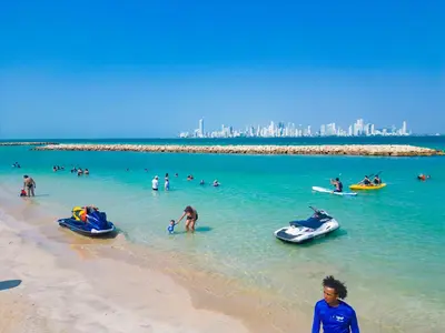 a group of people in the water at a beach at Palmarito Beach Hotel in Tierra Bomba