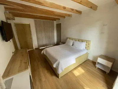 a bedroom with a white bed and a television at Palmarito Beach Hotel in Tierra Bomba