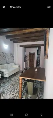 a living room with a table and a couch at Portalon de Magallanes apto para familias in Cartagena de Indias
