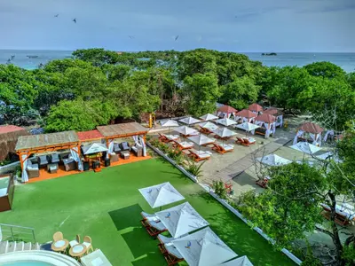 an aerial view of a resort with tables and umbrellas at Pao Pao Cartagena in Isla Grande