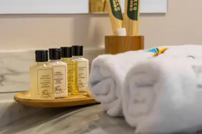 three bottles of shampoo and towels on a counter at Pao Pao Cartagena in Isla Grande