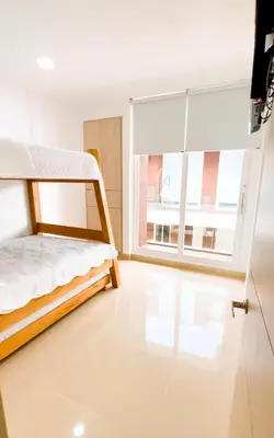 a bedroom with a bed and a large window at Paraíso frente al mar in Coveñas