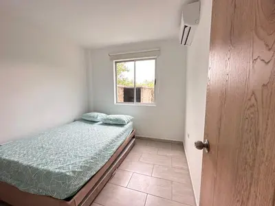 a small bedroom with a bed and a window at Cabaña 5 Playa Piso 1- Palmar De Los Vientos-San Bernardo del Viento in Pueblo Coco