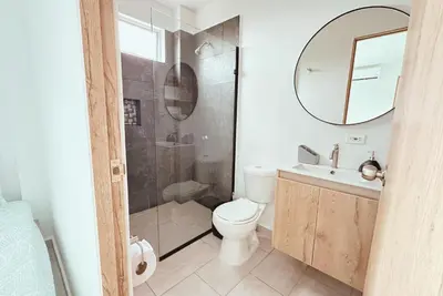 a bathroom with a toilet and a sink and a mirror at Cabaña 5 Playa Piso 1- Palmar De Los Vientos-San Bernardo del Viento in Pueblo Coco