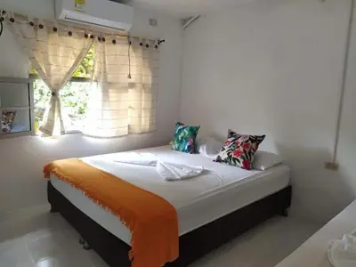 a large bed in a room with a window at San Jose de los Acuarios in San Antero