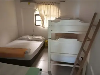 two bunk beds in a room with a window at San Jose de los Acuarios in San Antero