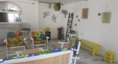a living room with two chairs and a table at San Jose de los Acuarios in San Antero