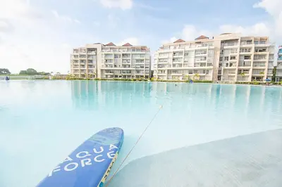 a paddle board in the water in front of buildings at U-GO Baia Kristal: Oasis Moderno en Cartagena in Cartagena de Indias