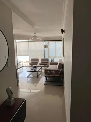 a living room with a couch and a table at Sleep by the Caribbean in Cartagena de Indias