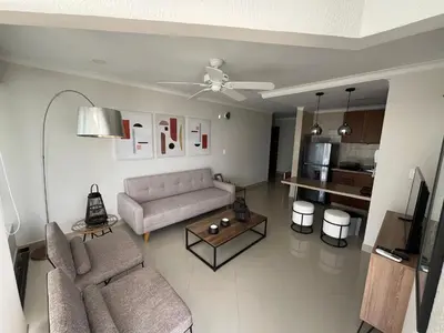 a living room with a couch and a table at Sleep by the Caribbean in Cartagena de Indias