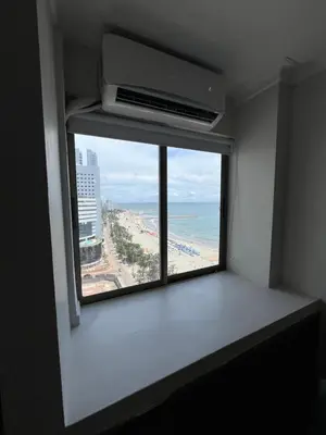 a room with a window with a view of the beach at Sleep by the Caribbean in Cartagena de Indias