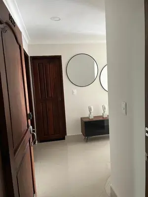 a room with two mirrors on the wall and a door at Sleep by the Caribbean in Cartagena de Indias