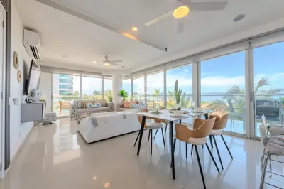 a living room with a table and chairs at Morros Epic Beachfront Apartment in Cartagena de Indias