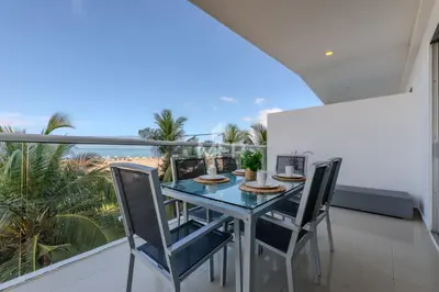 a dining room with a table and chairs on a balcony at Morros Epic Beachfront Apartment in Cartagena de Indias