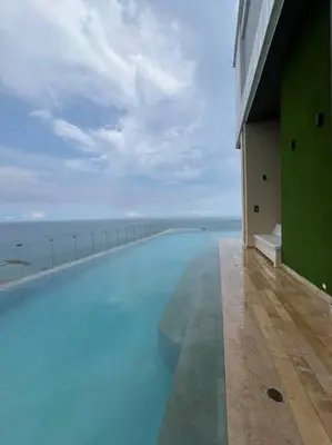 a large swimming pool with a view of the ocean at New Luxury Apartment in Cartagena in Cartagena de Indias