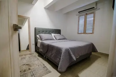a bedroom with a bed and a window at Santo Domingo - Centro Histórico in Cartagena de Indias