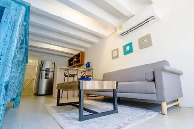a living room with a couch and a table at Santo Domingo - Centro Histórico in Cartagena de Indias
