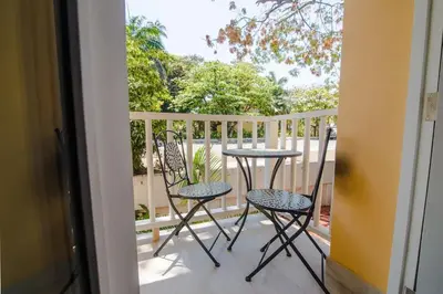 a balcony with two chairs and a table on a porch at Santo Domingo - Centro Histórico in Cartagena de Indias