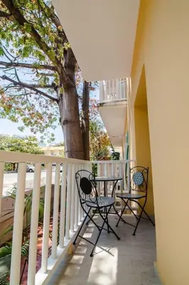 a patio with two chairs and a table on a balcony at Santo Domingo - Centro Histórico in Cartagena de Indias