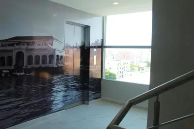 a room with a large window with a view of a building at Hotel OR Suite in Barranquilla