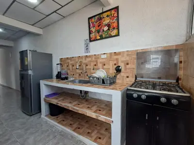 a kitchen with a sink and a stove and a refrigerator at LE REEVE, 3BR, Paz, Diseño Bohemio & Grupos in Cartagena de Indias