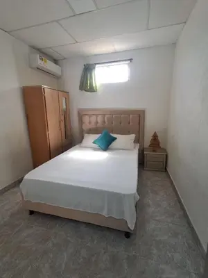 a bedroom with a white bed with a blue pillow at LE REEVE, 3BR, Paz, Diseño Bohemio & Grupos in Cartagena de Indias