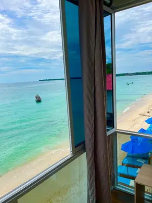 a room with a view of the beach from a window at Roma apartamento in Playa Blanca