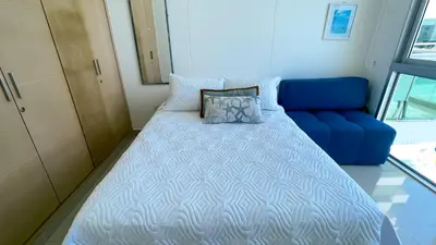 a bed in a room with a blue couch at Magico Apartamento Frente al Mar 4 Habitaciones BM63 in Coveñas