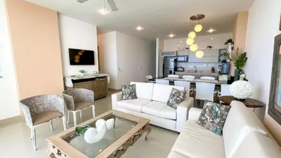 a living room with a white couch and a table at Magico Apartamento Frente al Mar 4 Habitaciones BM63 in Coveñas
