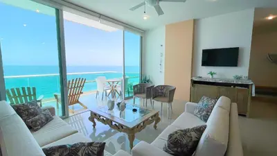 a living room with white furniture and a view of the ocean at Magico Apartamento Frente al Mar 4 Habitaciones BM63 in Coveñas