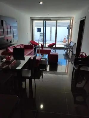 a living room with a couch and a table and chairs at Apartamento Coveñas Castillo Club Cabaña 5 in Coveñas