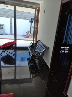a black bench sitting in a room with a window at Apartamento Coveñas Castillo Club Cabaña 5 in Coveñas