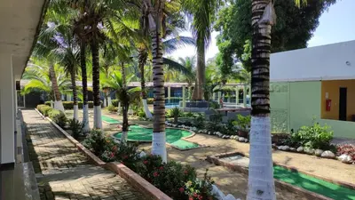 a row of palm trees in front of a building at Apartamento Coveñas Castillo Club Cabaña 5 in Coveñas