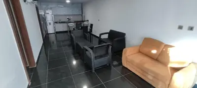 a living room with a couch and a chair at Apartamento Coveñas Castillo Club Cabaña 5 in Coveñas