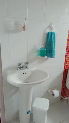 a white bathroom with a sink and a toilet at Confortable habitación en apartamento familiar en el Prado in Barranquilla