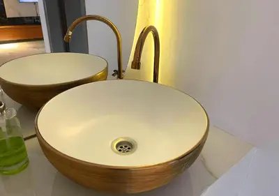 a bathroom with a sink with a wooden bowl at Apartaestudios Calle 76 in Barranquilla