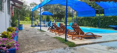 a group of chairs sitting next to a swimming pool at Mediterráneo Relax in San Antero