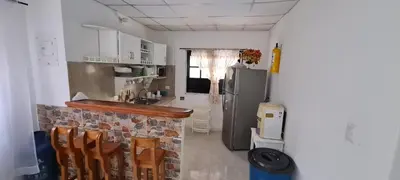a kitchen with a counter and a refrigerator at Mediterráneo Relax in San Antero