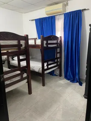 a room with two bunk beds and blue curtains at Mediterráneo Relax in San Antero