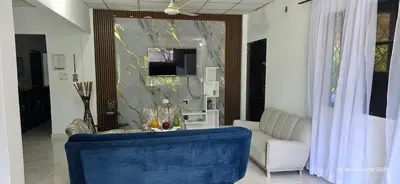 a living room with a blue couch and a mirror at Mediterráneo Relax in San Antero