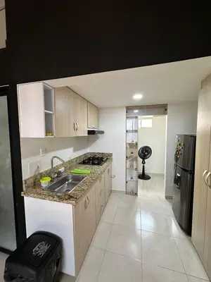 a kitchen with a sink and a refrigerator at Apartaestudio Amoblado Tipo Loft en Barrio la Campiña in Cartagena de Indias