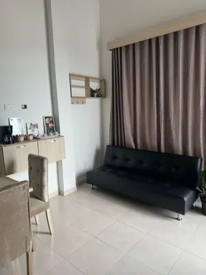 a living room with a black couch and a table at Apartaestudio Amoblado Tipo Loft en Barrio la Campiña in Cartagena de Indias
