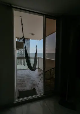 a room with a hammock and a view of the ocean at Stylish & Renovated Condo in El Laguito, Cartagena in Cartagena de Indias