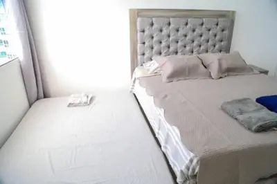 a bed in a room with a large window at Stylish & Renovated Condo in El Laguito, Cartagena in Cartagena de Indias