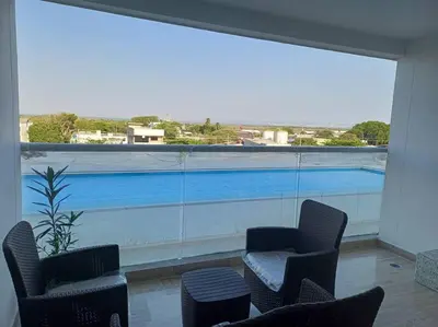 a room with two chairs and a large window at New Apartment very close to Airport and beaches in Cartagena de Indias